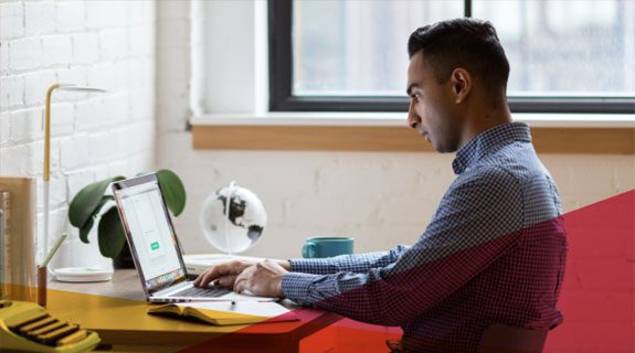 Man sitting at desk on laptop
