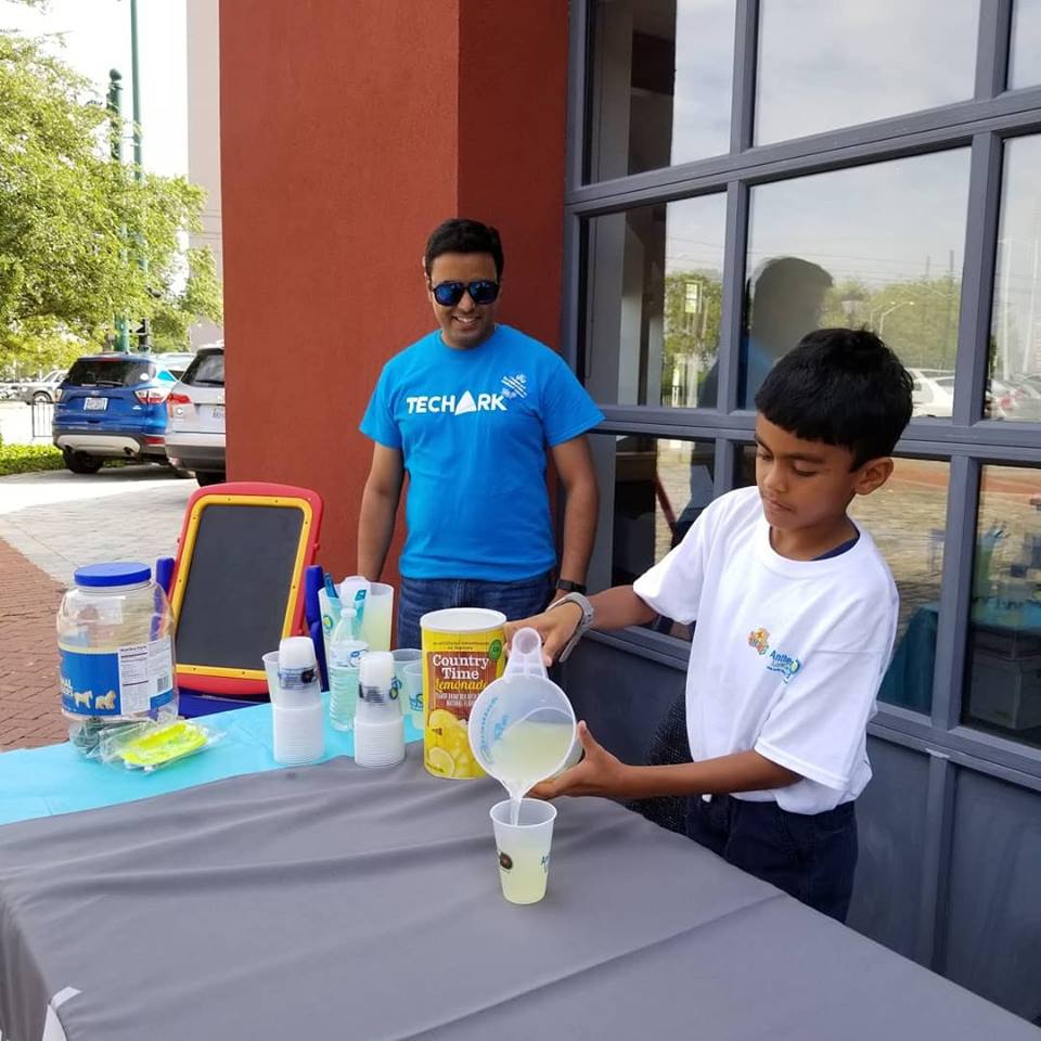 TechArk CEO and son passing out lemonade
