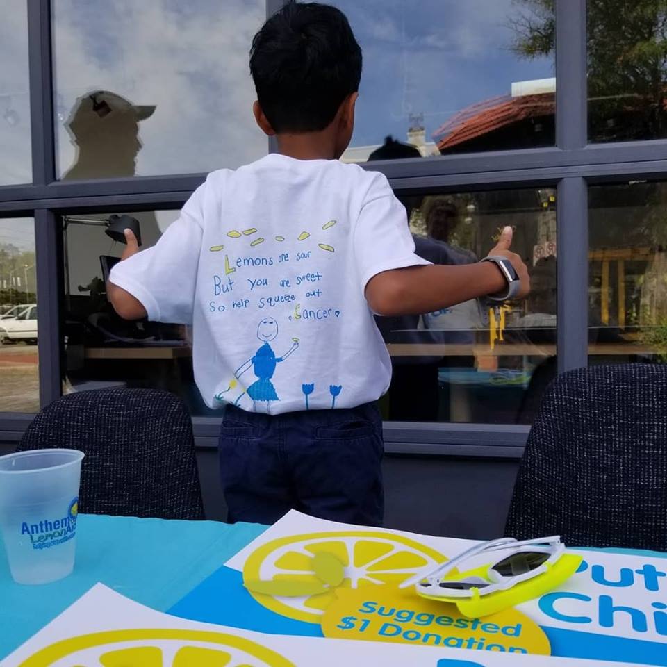 Child with tshirt at lemonade stand